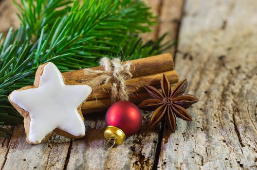 Christmas composition with star gingerbread and xmas spices on old table