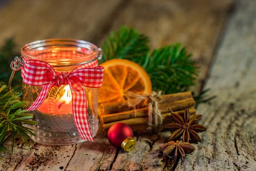 Festive atmosphere with burning christmas lantern candle and natural decoration