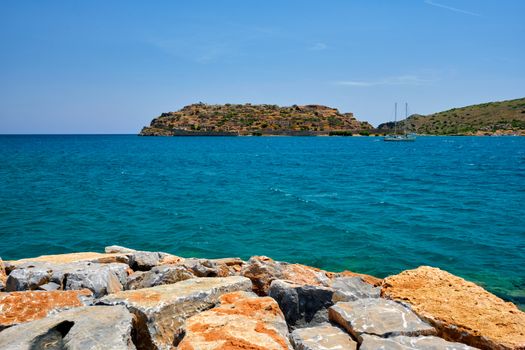 Island of Spinalonga with old fortress former leper colony and the bay of Elounda, Crete island, Greece