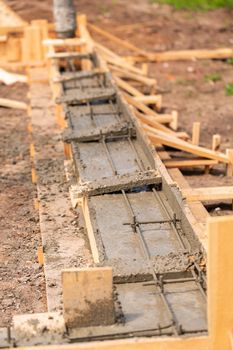 Lay of the cement or concrete into the foundation formwork with automatic pump. Building house foundation