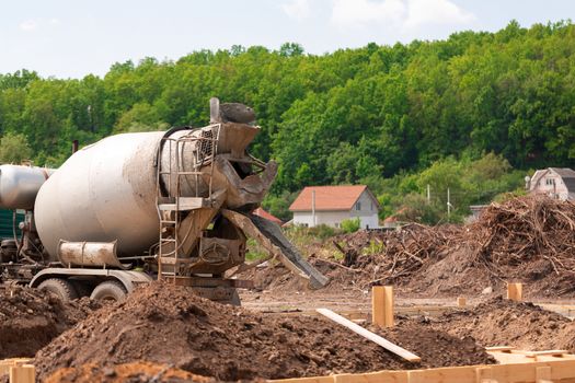 Lay of the cement or concrete into the foundation formwork with automatic pump. Building house foundation