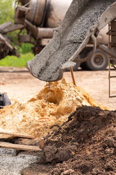 Lay of the cement or concrete into the foundation formwork with automatic pump. Building house foundation