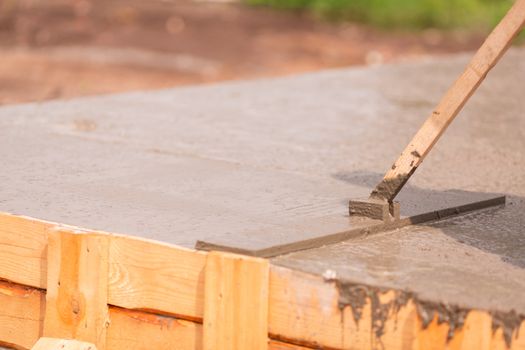 Leveling of the cement or concrete of the foundation formwork from concrete mixer. Building house foundation