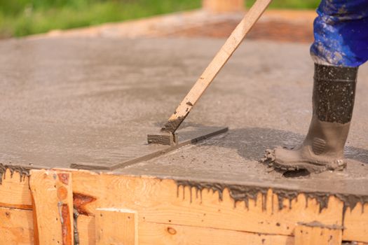 Leveling of the cement or concrete of the foundation formwork from concrete mixer. Building house foundation