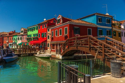 Burano island canal with the famous colored houses