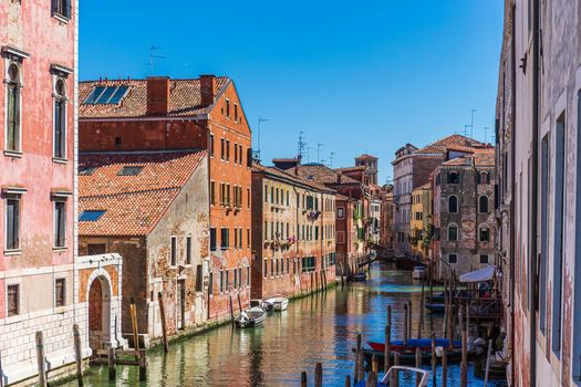 Burano island canal with the famous colored houses