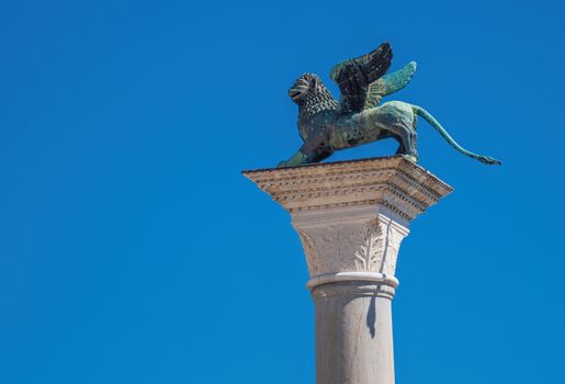 The ancient winged lion in front of the Doge's palace on its high plinth