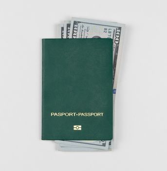 green passport with american dollars on white background, isolated
