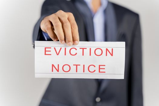 House Landlord or lawyer in suit showing eviction notice on isolated background