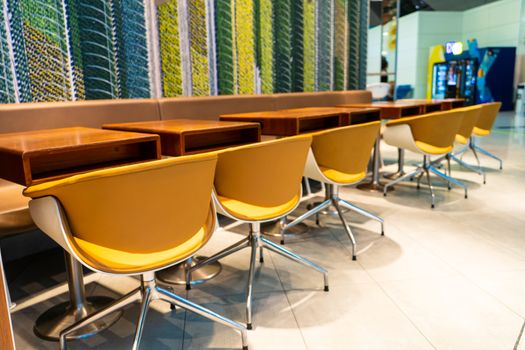 The interior of the waiting room. A row of chairs near the bar shelf