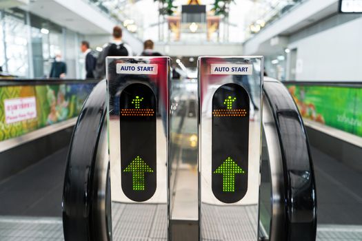 A moving walkway in modern large international airport. Travelator machine for moving passengers in large buildings