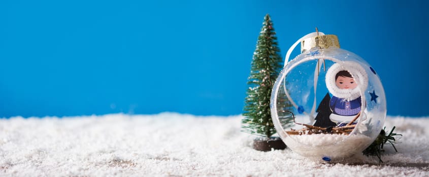 Holiday Christmas decoration on snow and blue background. Copyspace