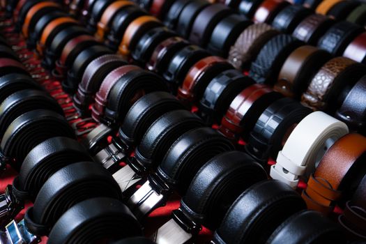 Clothing store, shelf with men's waist belts.