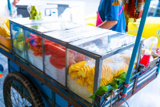 Street food seller in Asia. Mobile store food cart on wheels.