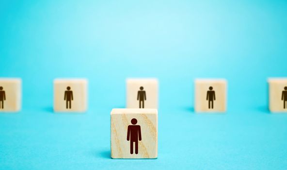 A block man stands out from a row number of people. Leader, leadership skills. Filling of vacancies with professional specialists. Staffing. Talented employee. Concept of individuality and personality