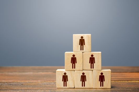 Blocks pyramid with people. Joint efforts to achieve goal. Teamwork, cooperation and collaboration. Team building, company hierarchical power vertical system. Strength in unity. Joining around idea