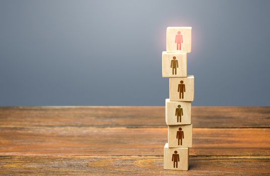 Red leader on top of a tower of people. Leadership skills. Teamwork, cooperation and collaboration. Management of effective and powerful team. Risk management and even distribution of work load.