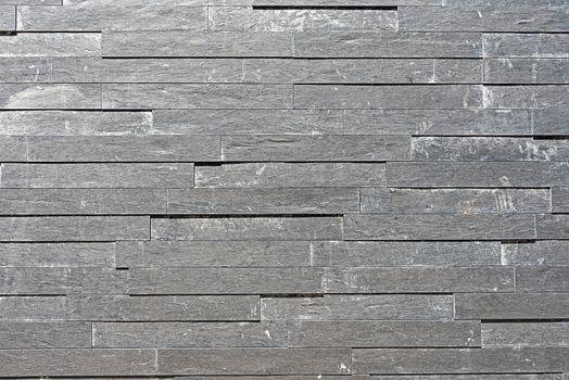 Background from a grey granite tiled wall