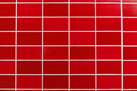 A red tiled background with relatively small tiles
