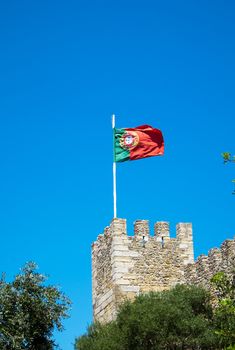 The portuguese flag waving in an old castle