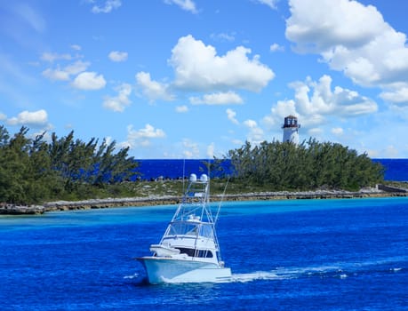 A Fishing Boat Entering a Channel by a Lighthouse in Nassau Bahamas