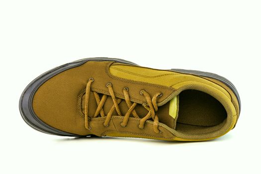 one right cheap yellow fabric hiking shoe isolated on white background.