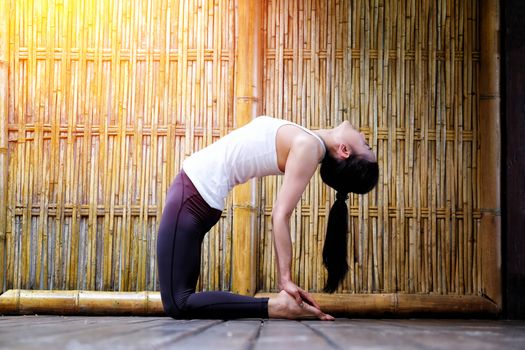 Woman yoga in nature bamboo background