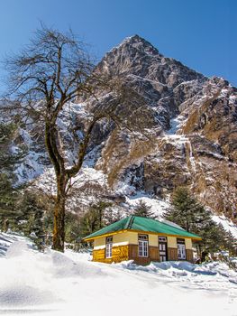 View of Log Hut on snow filled way to La Chung in Sikkim state of India.