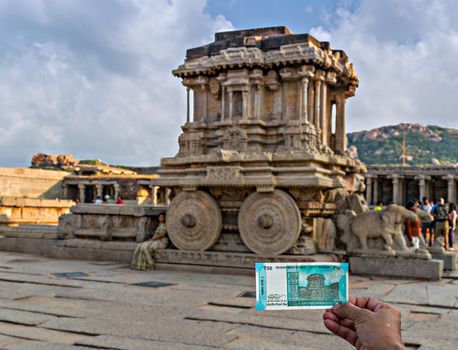 Image of Rs.50 Indian currency note that features richly sculpted ancient stone chariot at Viththla temple in Hampi, Karnataka. It is considered to be the most stunning architecture of the Vijayanagara kingdom.