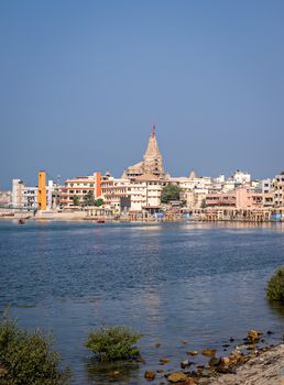 Gomathi ghat and view of  Dwarkadheesh temple in Gujrat, India with clear blue sky.