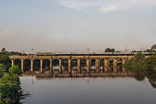 Pune to Mumbai super fast Intercity express train passing over Harris bridge in Dapodi, making a nice reflection in waters of Mula river.