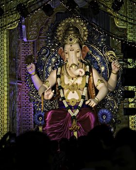 Closeup , portrait view of decorated and garlanded  idol of Hindu God Ganesha in Pune ,Maharashtra, India.