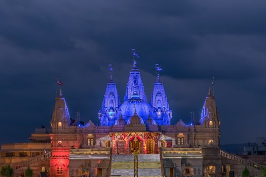 Lighted image of Shree Swaminarayan temple with monsoon clouds background, Ambe Gaon,  Pune .