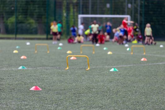 Children competing during school sports day in the UK. Blurred image with selective focus.