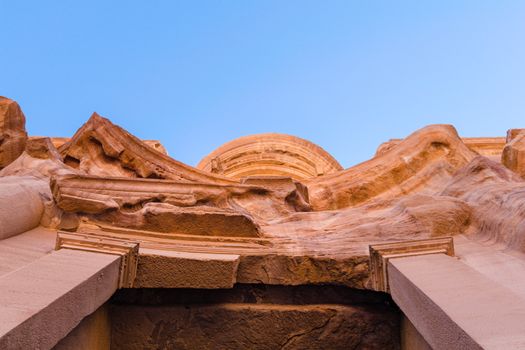 Detail of stone carved facade of El Deir Monastery, a famous landmark and viewpoint in World Heritage Site of Petra, Jordan, Middle East