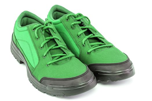 a pair of light green hiking shoes isolated on white background - perspective close-up view.