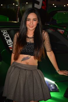 PASAY, PH - DEC. 7: Car show female model at Bumper to Bumper 15 on December 7, 2019 in Mall of Asia Concert Grounds, Pasay, Philippines. Bumper to Bumper is a annual aftermarket car show event in the Philippines.