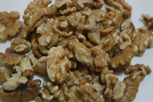 Close-up top view of peeled walnut on a white background. peeled walnut without shell ready to eat dry fruit.