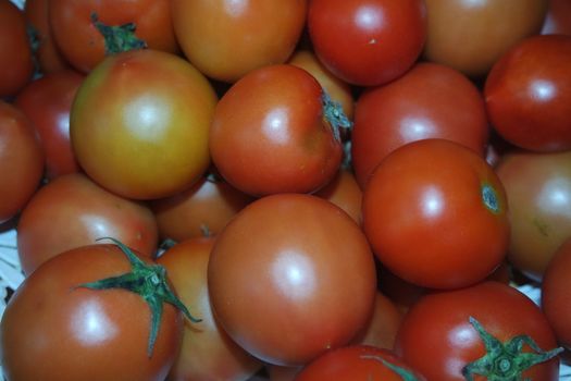 Close-up view of red tomatoes in market for sale. A fruit background for text and advertisements