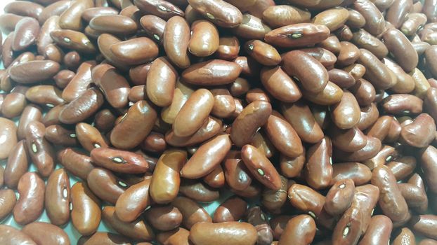 Kidenry beans:   Closeup view of uncooked red kidney beans. Dark red useful beans background.