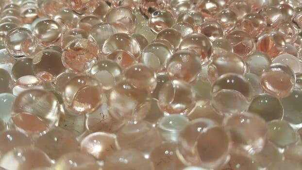 Closeup view with selective focus of shiny glittering orbeez or colorful water balls hydrogel. Water beads orbeez background.