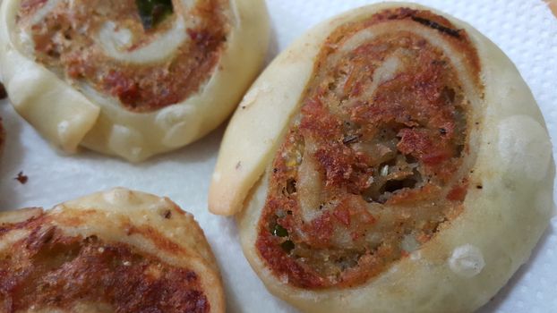 Closeup of delicious home made pinwheel puff pastries food item placed over white background