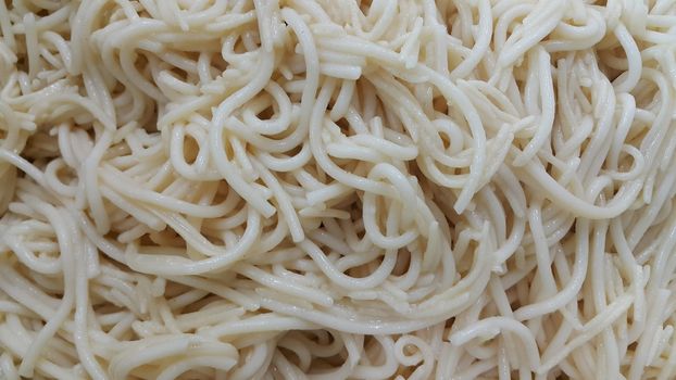 close up view of swirling noodles or spaghetti pasta for eating. Food background for fast foods