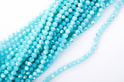 Beautiful Light Blue Glass Sparkle Crystal Isoalted Beads on white background. Use for diy beaded jewelry. Space for text