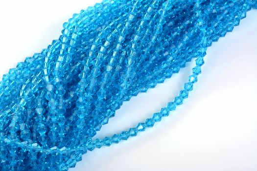 Beautiful Light Blue Glass Sparkle Crystal Isoalted Beads on white background. Use for diy beaded jewelry. Space for text