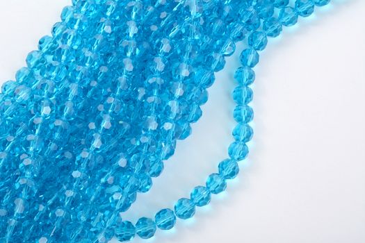 Beautiful Light Blue Glass Sparkle Crystal Isoalted Beads on white background. Use for diy beaded jewelry. Space for text