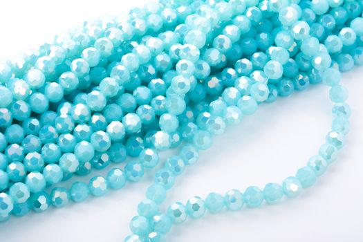 Beautiful Light Blue Glass Sparkle Crystal Isoalted Beads on white background. Use for diy beaded jewelry. Space for text