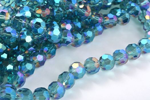 Beautiful Light Blue Glass Sparkle Crystal Isoalted Beads on white background. Use for diy beaded jewelry. Space for text