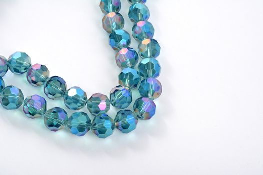 Beautiful Light Blue Glass Sparkle Crystal Isoalted Beads on white background. Use for diy beaded jewelry. Space for text