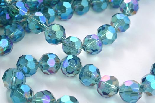 Beautiful Light Blue Glass Sparkle Crystal Isoalted Beads on white background. Use for diy beaded jewelry. Space for text